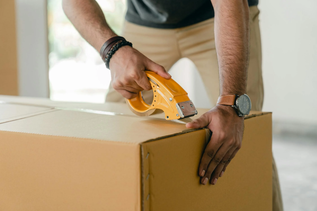 courier service representative sealing a box